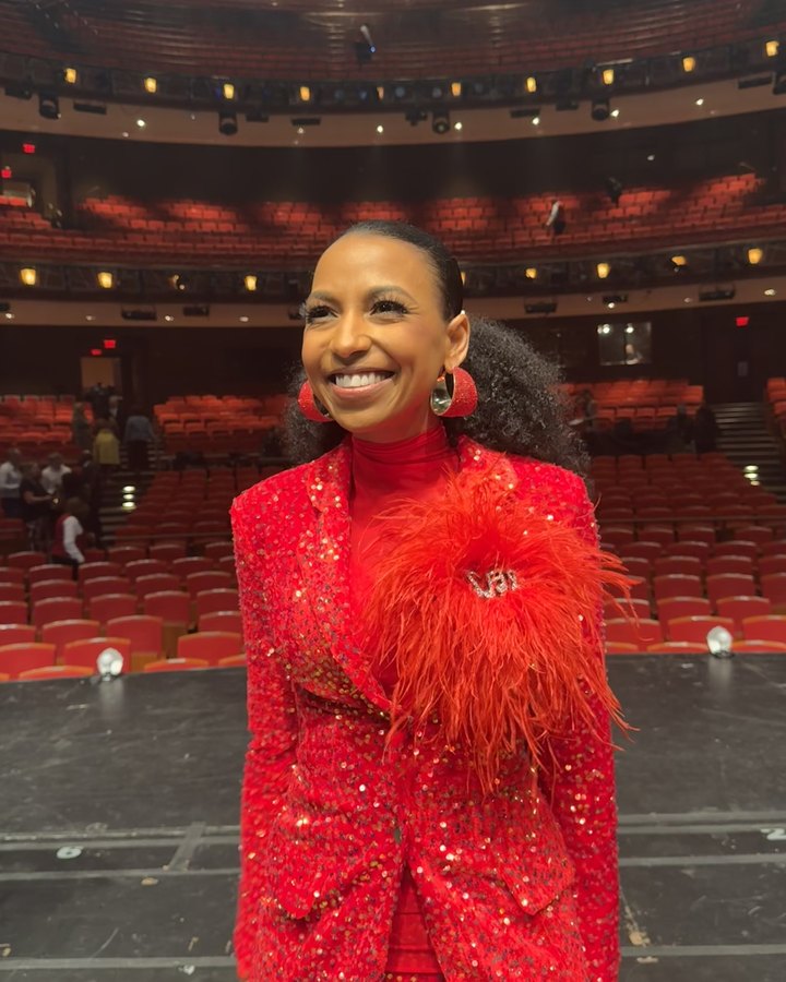Chelsea in a red sequin suit on stage in an empty theater before the broadcast