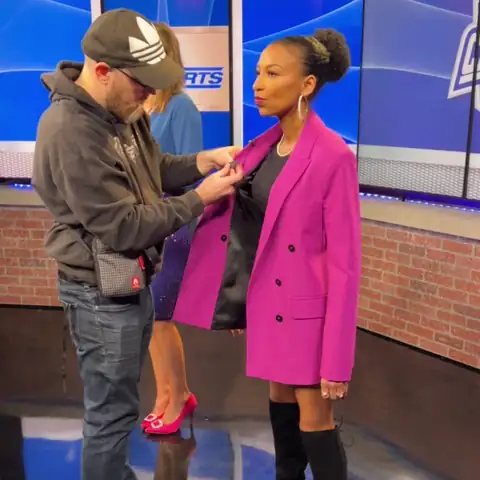 Looping clip: Chelsea getting mic'd up on the GHSA Cheerleading State Championships set