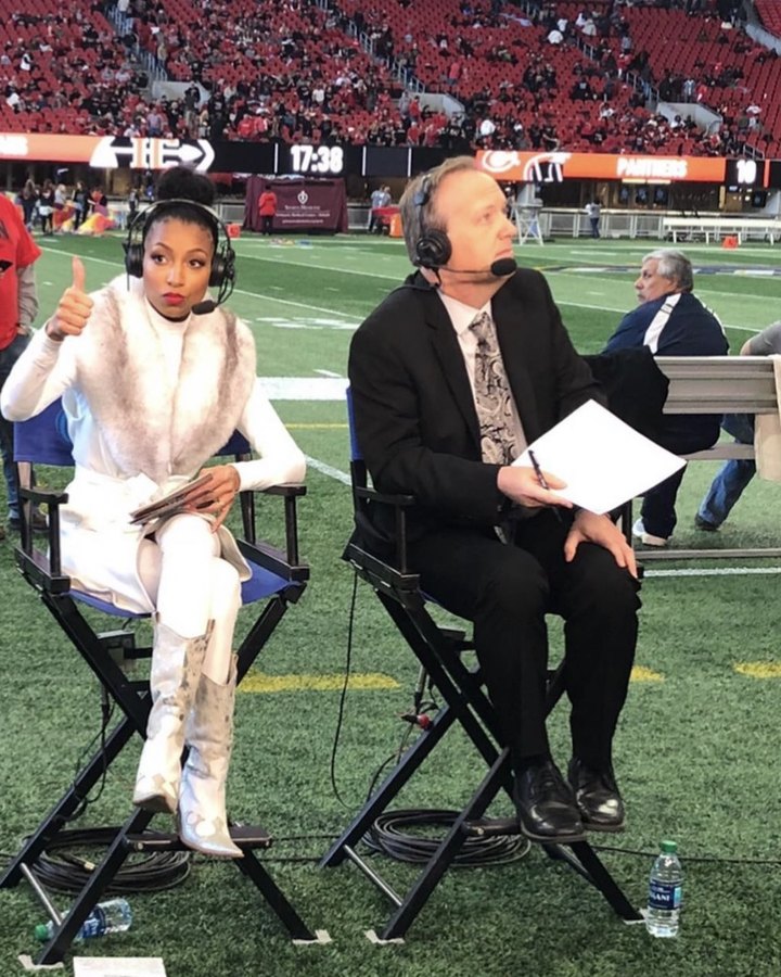 Chelsea on headset in an anchor chair on the football field during a live GPB broadcast